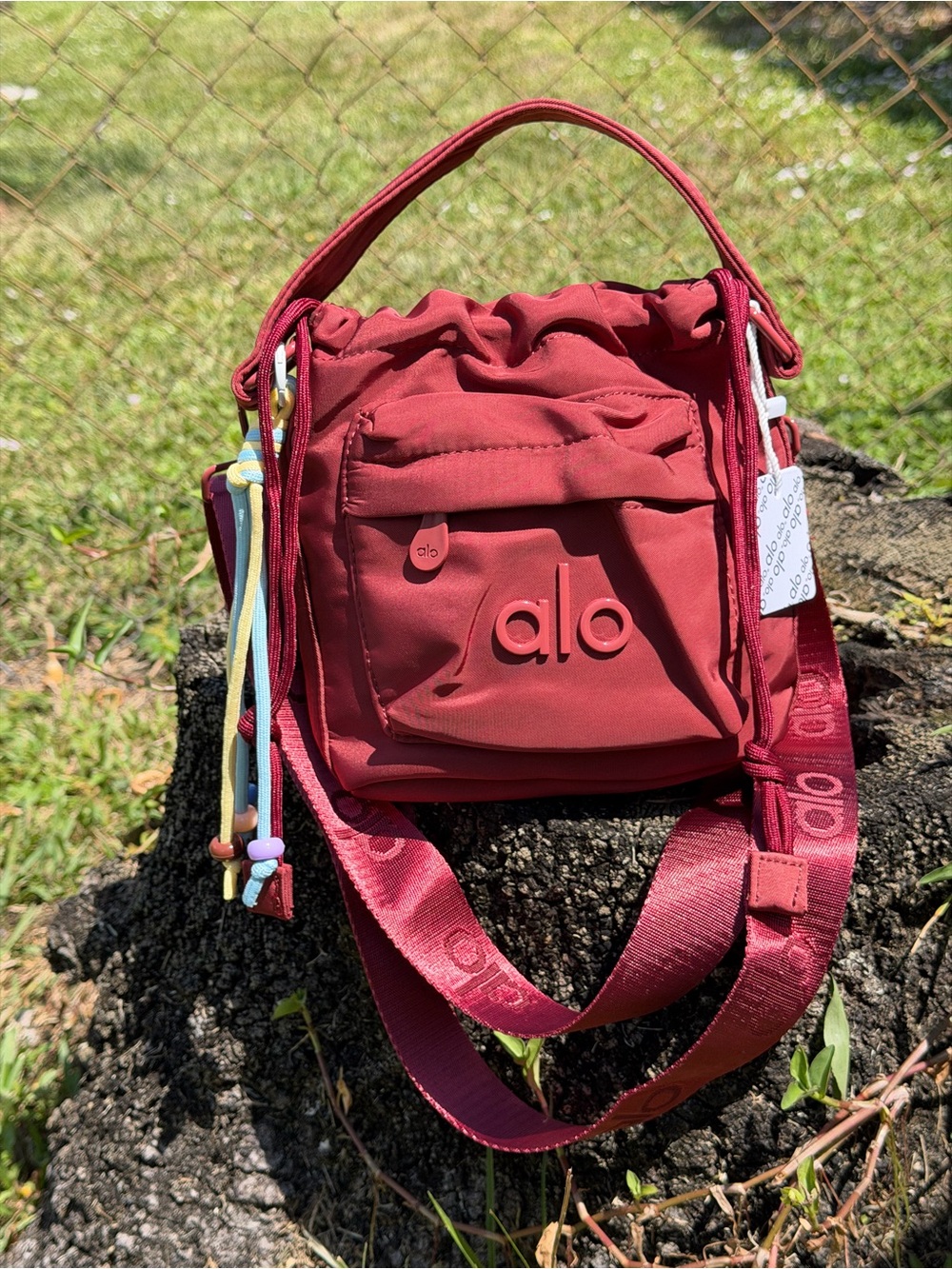 ALO Yoga Burgundy Drawstring Mini Bucket Bag with Multicolor Cord Tassels